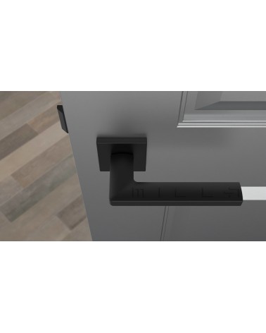 Puxador de porta preto PYROLA ferragens design vista de cima montado numa porta