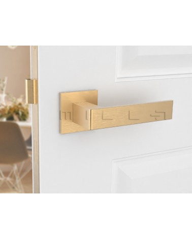 Puxador de porta dourado mate Apollo design vista frontal montado numa porta