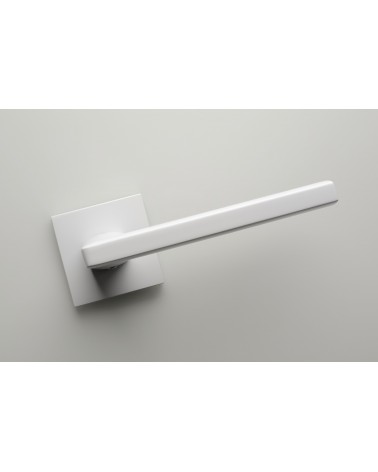 Puxador de porta branco PYROLA ferragens design vista de frente inclinado montado numa porta