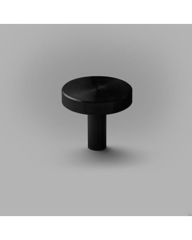Botão de móvel preto NENA M puxador design colocado sobre uma superfície plana