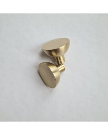 Puxador de móvel dourado mate LUNA M design pousados lado a lado sobre uma superfície plana