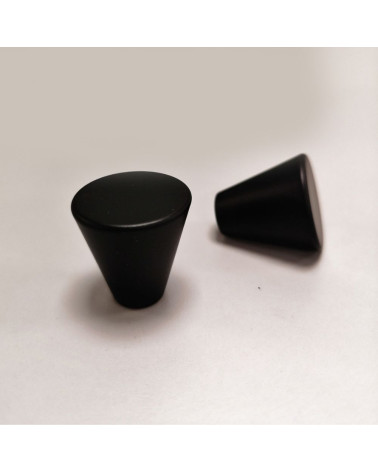 Puxador de móvel preto AMBIENT design pousado sobre um fundo
